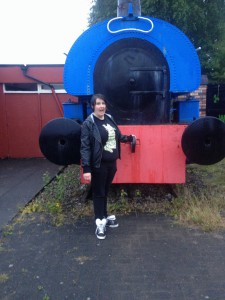 I made Kate stop in the rain so I could take this pic of her with a train.